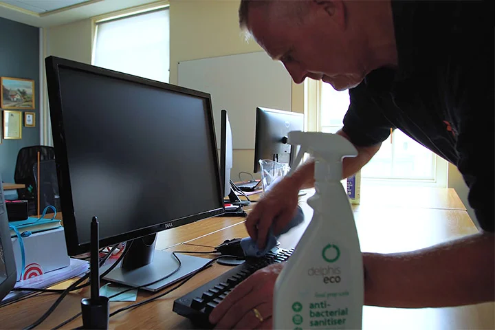 Cleaning desk and computers at business premises